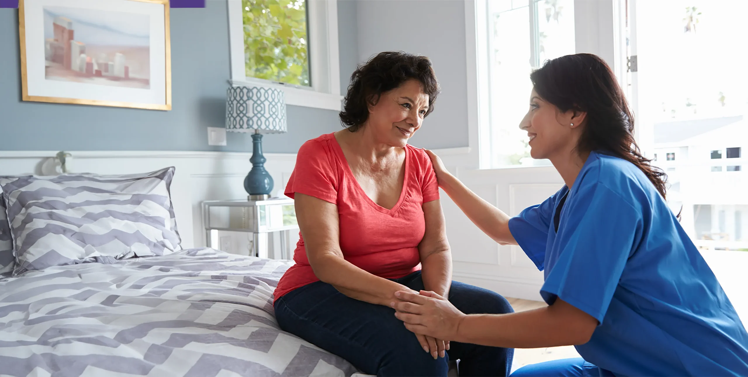 Caregiver talking with an older woman at home
